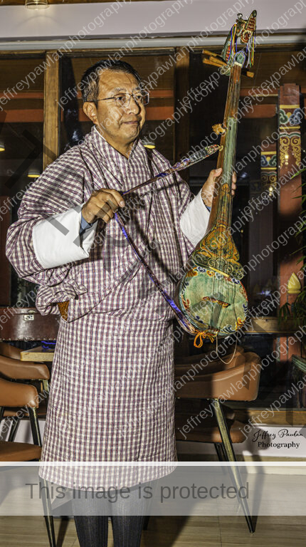 920300-Jigme-Drukpa-holding-the-dranyen-signed-WP-430x768
