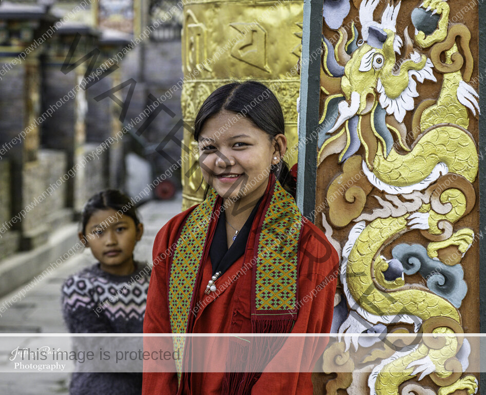 920578-Bhutan-girls-at-the-demon-pillar-signed-WP-1-946x768